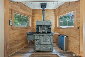 Unique antique wood stove used as storage adds character to the kitchen space.