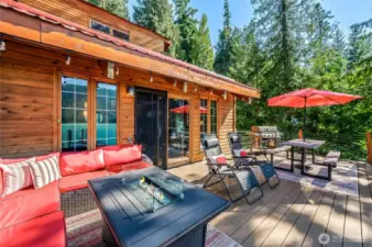 Gather around the cozy firepit on the deck, overlooking stunning lake and mountain views.