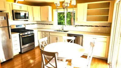 Cheery, bright kitchen with soft closing cabinet doors and drawers. Sliding door to front deck.