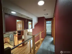 Upper Level Hallway looking toward the Main Full Bath and view to the Kitchen.Note the Solatube that reflects natural light year round.
