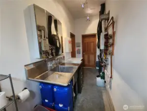 Shop Bathroom view toward the two separate entrances to each; large shop and smaller shop.