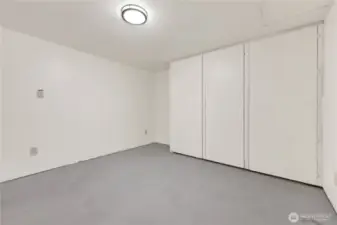 Storage room with access to plumbing in bathroom above
