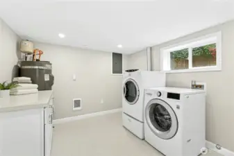 Very roomy utility room with cabinet space.