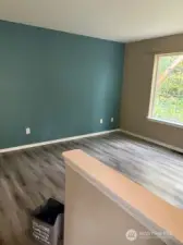 Standing in the open door, inviting you into a living room filled with warmth and comfort.