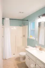 A chic contemporary bathroom awaits, complete with state of the art shower stall for a refreshing experience and a conveniently located toilet designed for every day comfort.