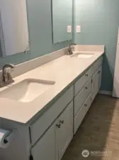 Enjoy the comfort of a spacious primary bathroom with dual sinks.