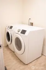 A spacious room at the end of the hallway, perfect for your needs. Plus, the washer and dryer stays with the home, offering added convenience.