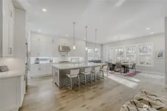 Sunlight pours through oversized windows, highlighting the home’s airy living spaces.