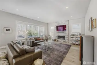 The Great room is enhanced by Hunter Douglas window coverings and an oversized fireplace with statement designer accent tiles.