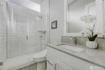 A modern, yet understated guest 3/4 bathroom on the main floor.