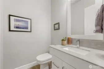 The main level powder room is understated and inviting.