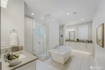 Oversized ceramic floor tiles, individual vanities with toe-kick subtle floor lighting, and ample cabinetry and counter space perfectly blend elegance with functionality.