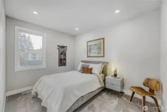 The upper floor fourth bedroom is sunlit, cheerful, and features a walk-in closet.