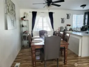 The Formal Dining Room with Cathedral Ceiling, Newer Laminate Flooring Looking into the Dining Room.