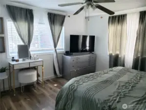 Another View of the Spacious Primary Master Bedroom with Newer Paint, Trim and Vinyl Plank Flooring from the Primary Bath Room.