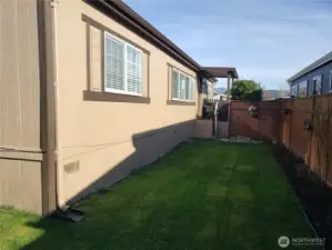 A Different View from the Manicured Side yard that lead to the Covered Porch and Front Entry Door.