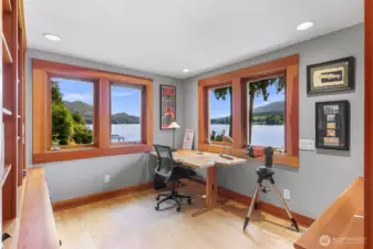 Flexible space adjoining the primary bedroom can be configured as a home office, reading or craft area, or even a nursery. Sunny Lake Samish and lush greenery visible from each window.
