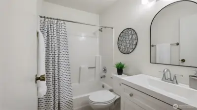 Updated bathroom with new vanity and toilet is bright and spacious.