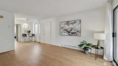 Open layout combines living room with kitchen area for easy flow and function. Side door and path leads to fully fenced back yard and back alley parking.