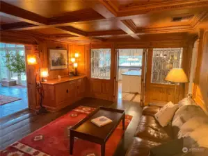 Luxurious parlor complete with a beautiful free-standing stove and masterfully created knotty pine walls, ceiling and decorative molding.