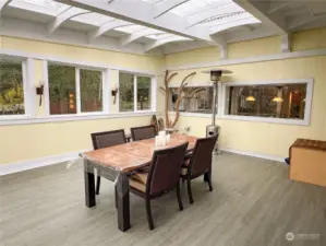 Covered and protected out-door dining and entertaining area with a deck and steps to the "back yard."