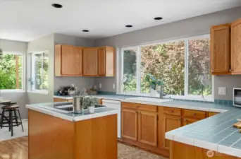 Kitchen with sweet eating spaces at the counter or in the nook - and great island for cooking!