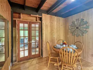 Cute dining area opens to living space through French doors and has slider to outaide