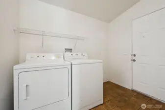 Laundry/mudroom that leads to the fully chain linked back yard, with 2 gates.