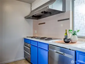 Look for the charming grill at the stove’s end, a unique touch for warm, ready-to-serve dishes
