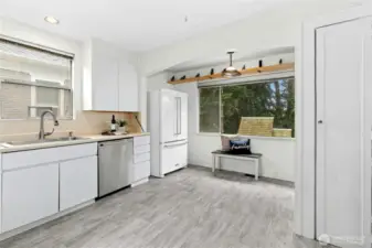The large kitchen has new flooring, (something about dishwasher), French door fridge, and room for a small table or island. Don't miss the pantry to the right.