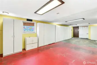 The daylight, partially finished basement has SO MUCH POTENTIAL! The door leads to the front of the home. All of the new-ish storage cabinets are included in the sale.