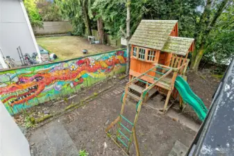 The backyard has personality and potential. The mural is by local artist Michael O'Driscoll.