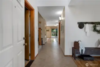 Tiled entry to the home, garage entrance is on the left, Formal Living Room is on the right.