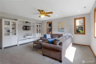 This is the Bonus Room on the main floor with an attached Entertainment Center. This room is just through the door off of the informal living space.