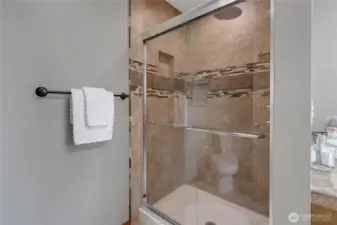 Tiled step in shower in Primary Bath.