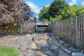 Fire Pit in the back corner of the yard.