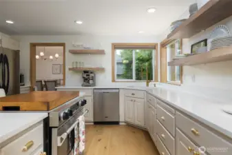 Another view of the kitchen w/gas range/oven, LVP flooring. Dining room through the doorway at left.  Recent updates include engineered hardwood floor, dishwasher, new fixtures and hardware.