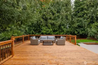 The large deck has multiple areas for seating and entertaining.