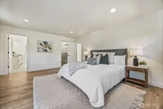 The primary bedroom is bright and spacious with a full attached bathroom and walk-in closet.