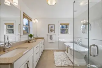 Full primary bathroom with double vanity and stand alone bathtub.