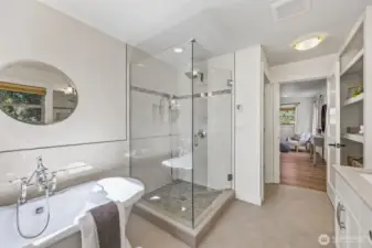 Full primary bathroom with double vanity and stand alone bathtub.