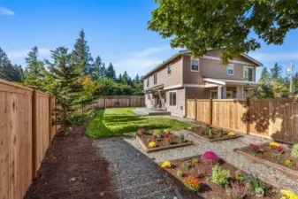 The fully fenced back yard is perfect to relax, garden, or play on our beautiful PNW days.