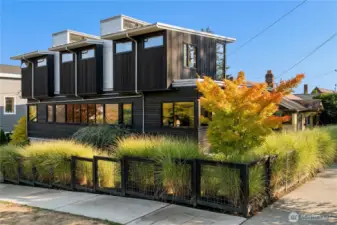 A striking modern profile with bold architectural lines, surrounded by lush landscaping for privacy and curb appeal.