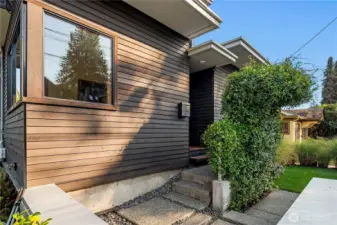 A private, understated entry welcomes you into this architectural retreat, wrapped in warm wood tones.