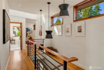 Soaring ceilings and natural light highlight the thoughtful design of the upper-level corridor.