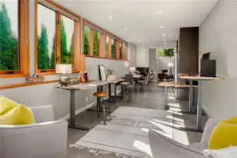 Expansive windows and custom workstations create a bright, inspiring space for work, study, or creativity.