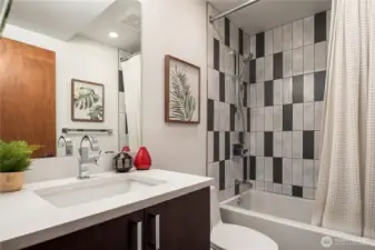 A chic full bath with striking black-and-white tile brings energy and modern style.