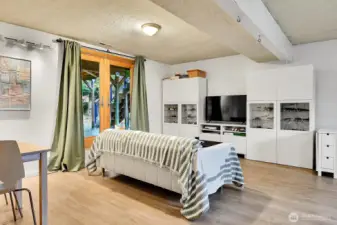 Heated LVP floors keep the lower level cozy, and there's access to the backyard through the gorgeous french doors!