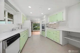 Bright kitchen with tons of counter space and cabinets.