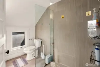 Unit #2015: Updated bathroom with fresh tile and glass shower surround.